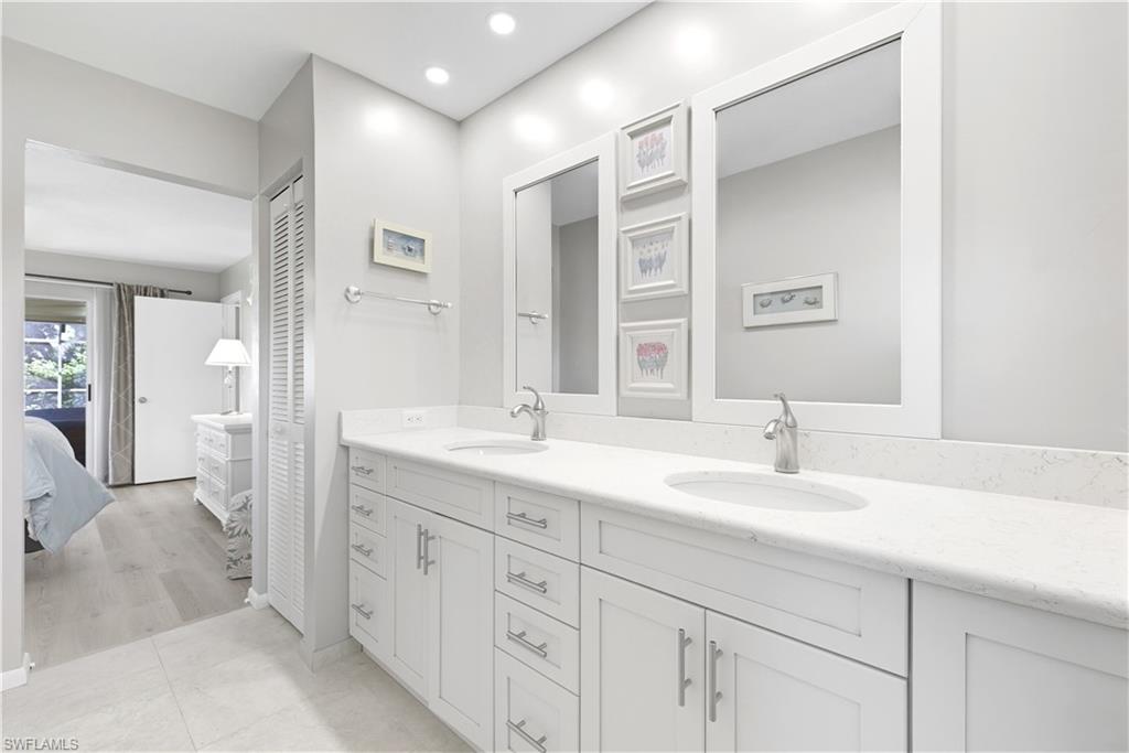 2261 Kings Lake Boulevard Naples, FL 34112 - Photo 21 of 43 a en suite bathroom with double sink and a mirror