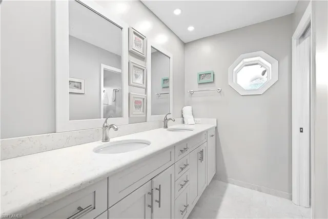 a bathroom with a double vanity sink and a mirror