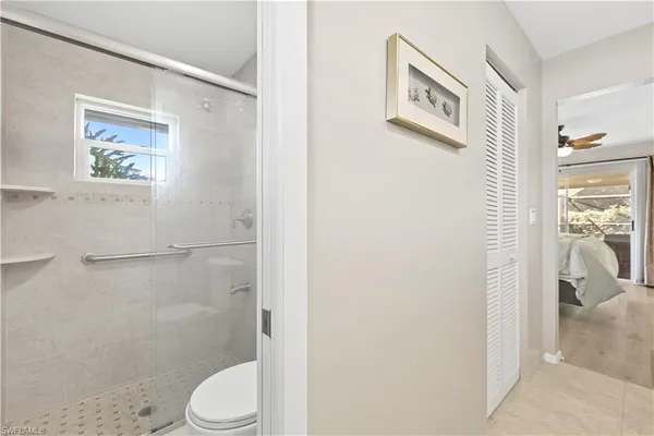 a white toilet sitting next to a bathroom sink