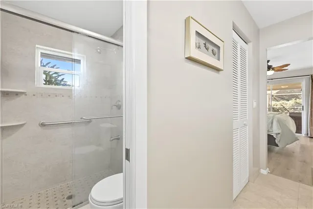 a white toilet sitting next to a bathroom sink