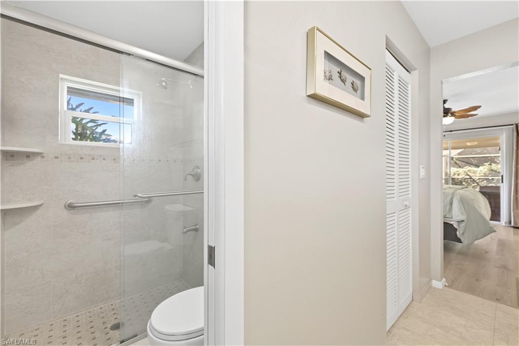 2261 Kings Lake Boulevard Naples, FL 34112 - Photo 23 of 43 a white toilet sitting next to a bathroom sink