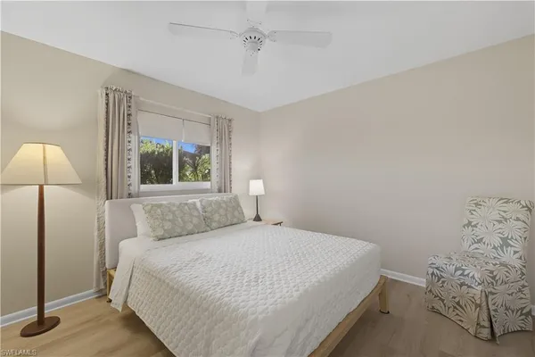 a bedroom with a bed and a lamp