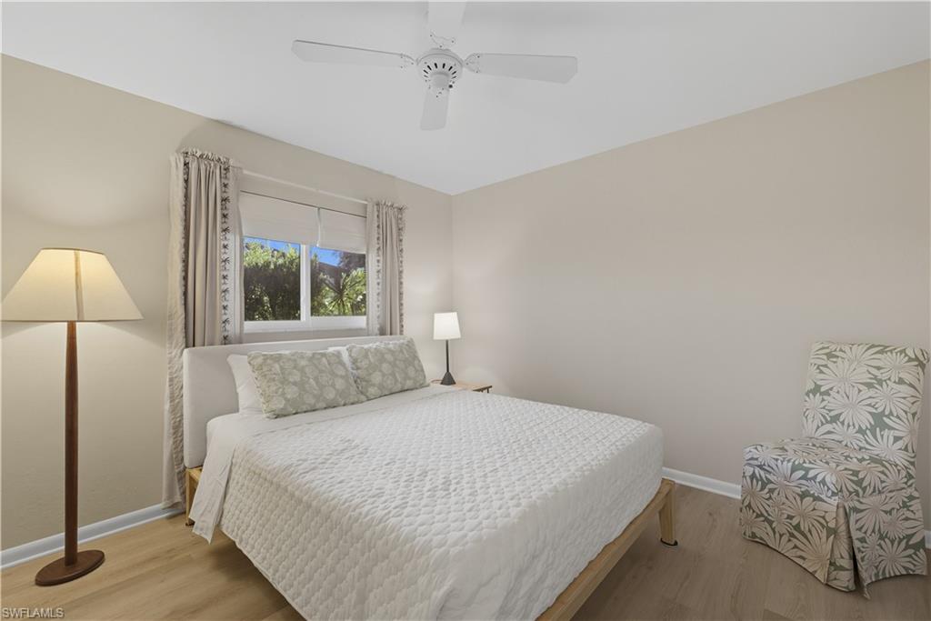 2261 Kings Lake Boulevard Naples, FL 34112 - Photo 24 of 43 a bedroom with a bed and a lamp