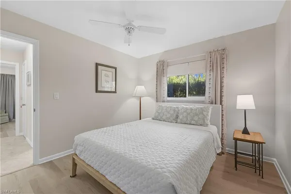 a bedroom with a bed and a lamp