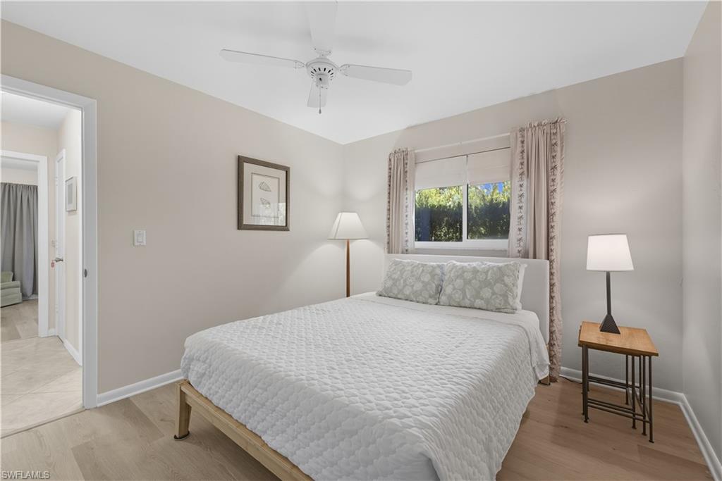 2261 Kings Lake Boulevard Naples, FL 34112 - Photo 26 of 43 a bedroom with a bed and a lamp