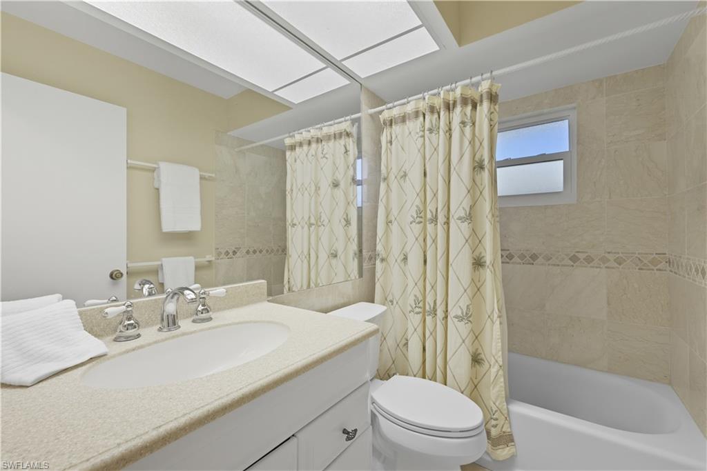 2261 Kings Lake Boulevard Naples, FL 34112 - Photo 27 of 43 a bathroom with a sink a toilet and shower