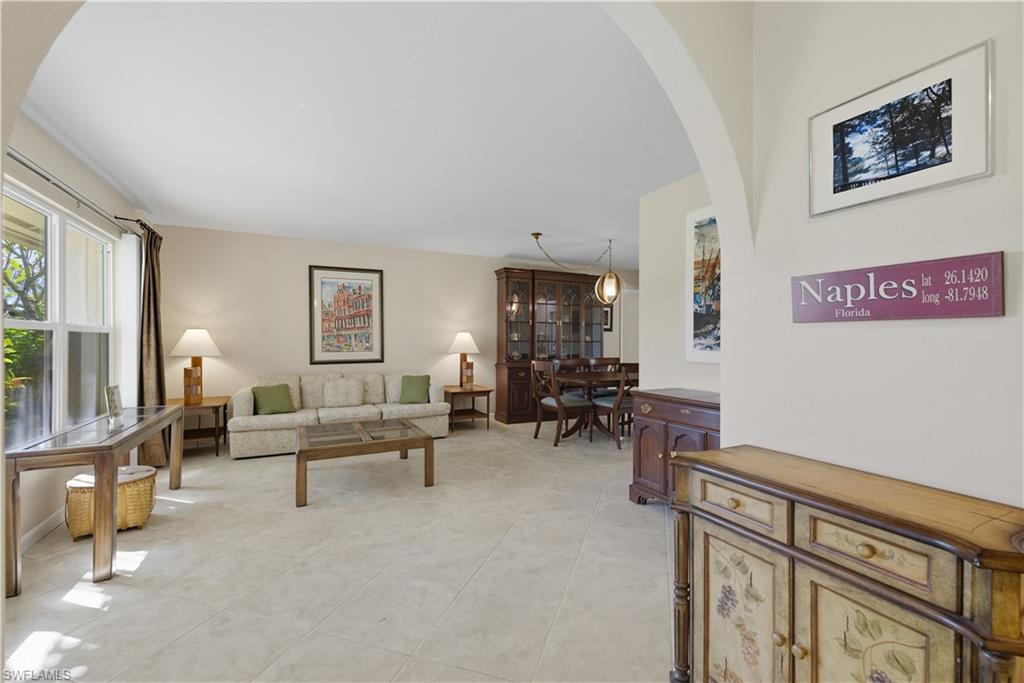 2261 Kings Lake Boulevard Naples, FL 34112 - Photo 3 of 43 a living room with furniture and a potted plant