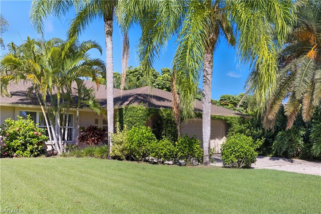 2261 Kings Lake Boulevard Naples, FL 34112 - Photo 33 of 43 a view of a backyard with plants