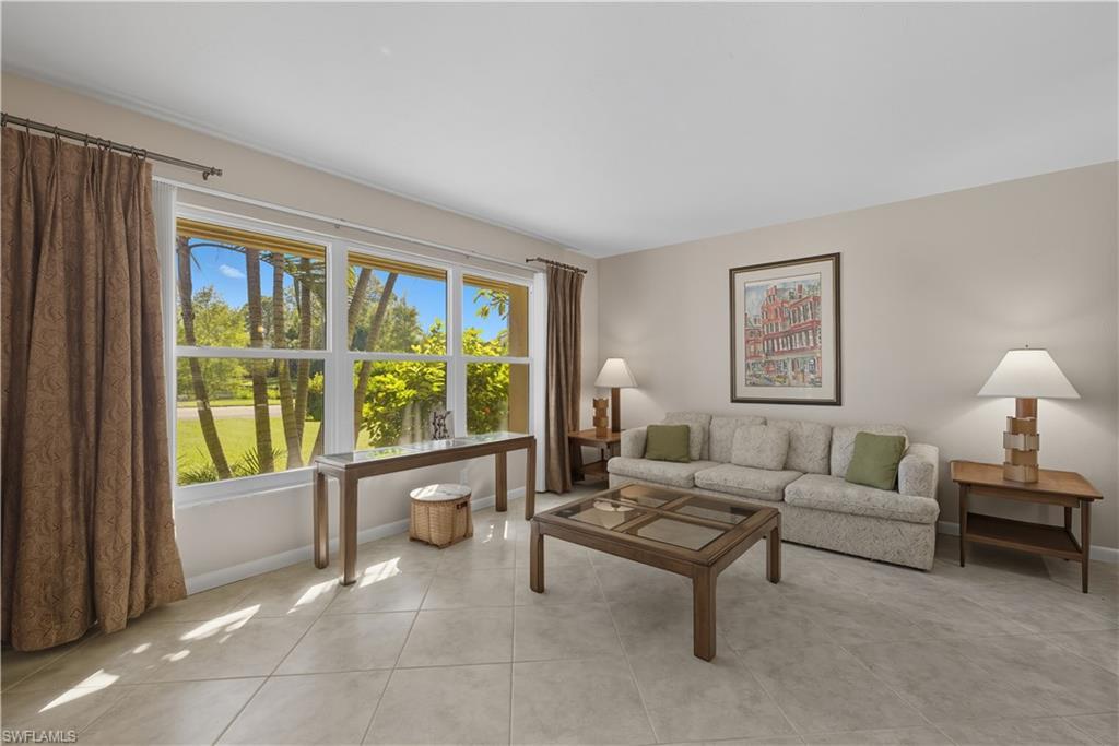 2261 Kings Lake Boulevard Naples, FL 34112 - Photo 4 of 43 a living room with furniture and a large window
