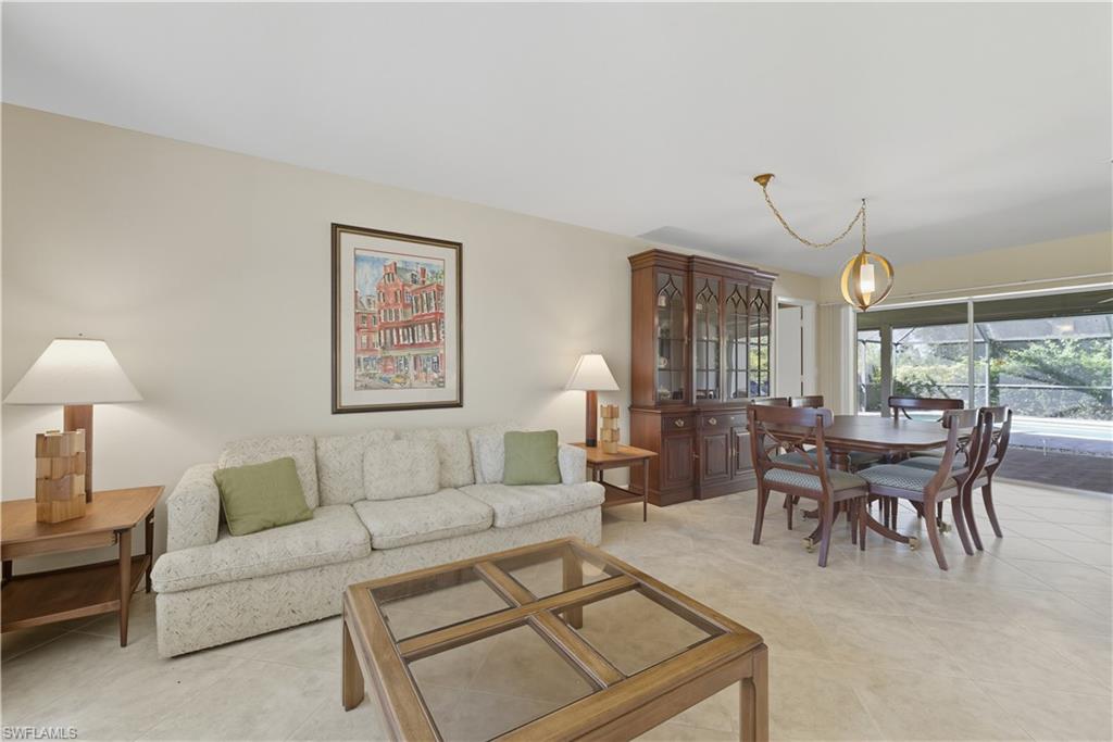 2261 Kings Lake Boulevard Naples, FL 34112 - Photo 5 of 43 a living room with furniture a table and a large window