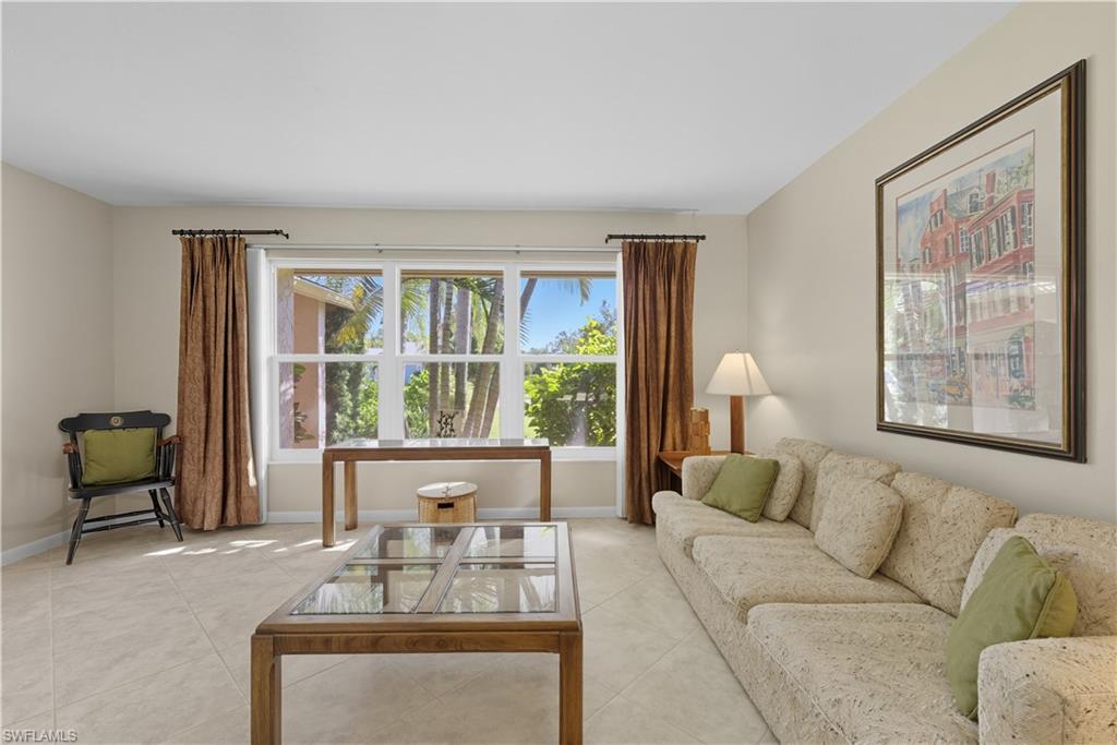 2261 Kings Lake Boulevard Naples, FL 34112 - Photo 6 of 43 a living room with furniture and a large window