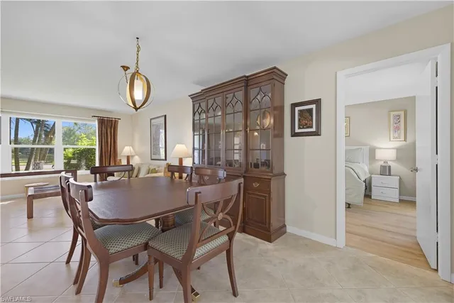 a view of a dining room with furniture and a chandelier