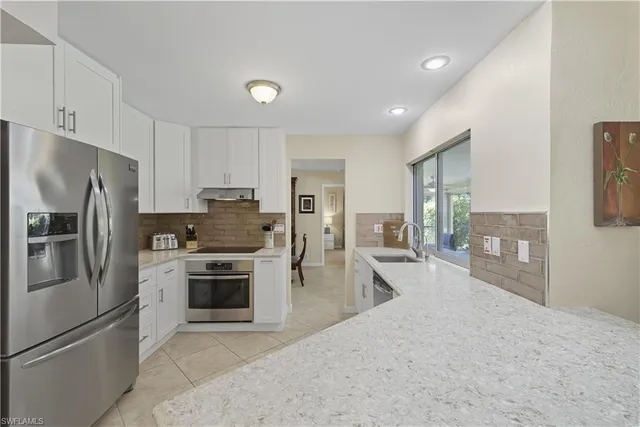 a kitchen with refrigerator a stove and cabinets