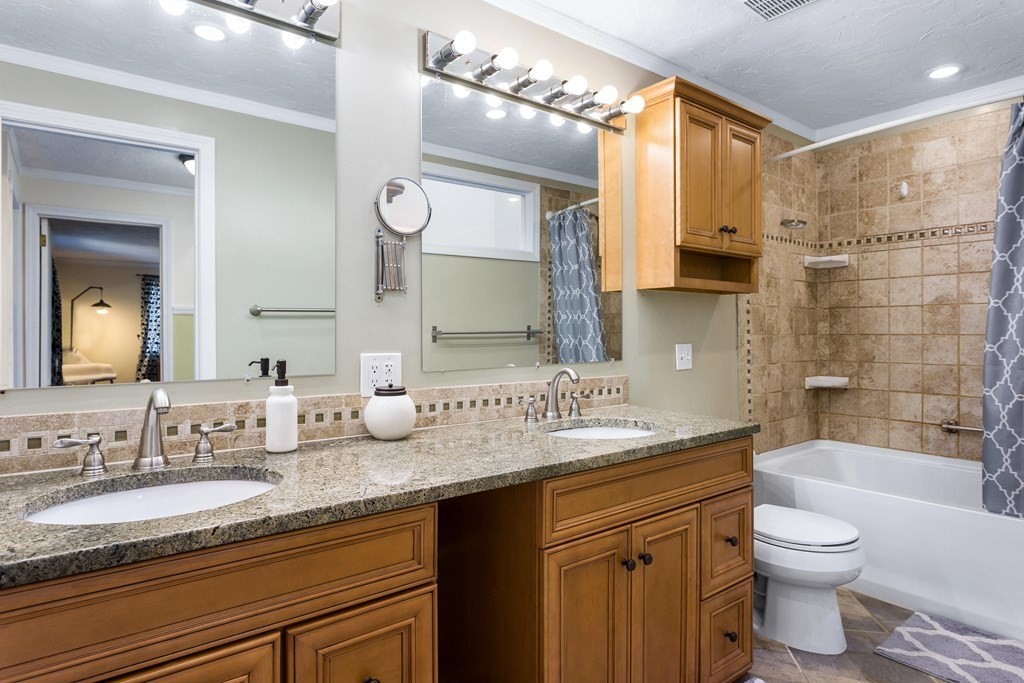 33 Trailside Way, Unit 33 Ashland, MA 01721 - Photo 14 of 26 a bathroom with a granite countertop sink mirror vanity bathtub and a toilet