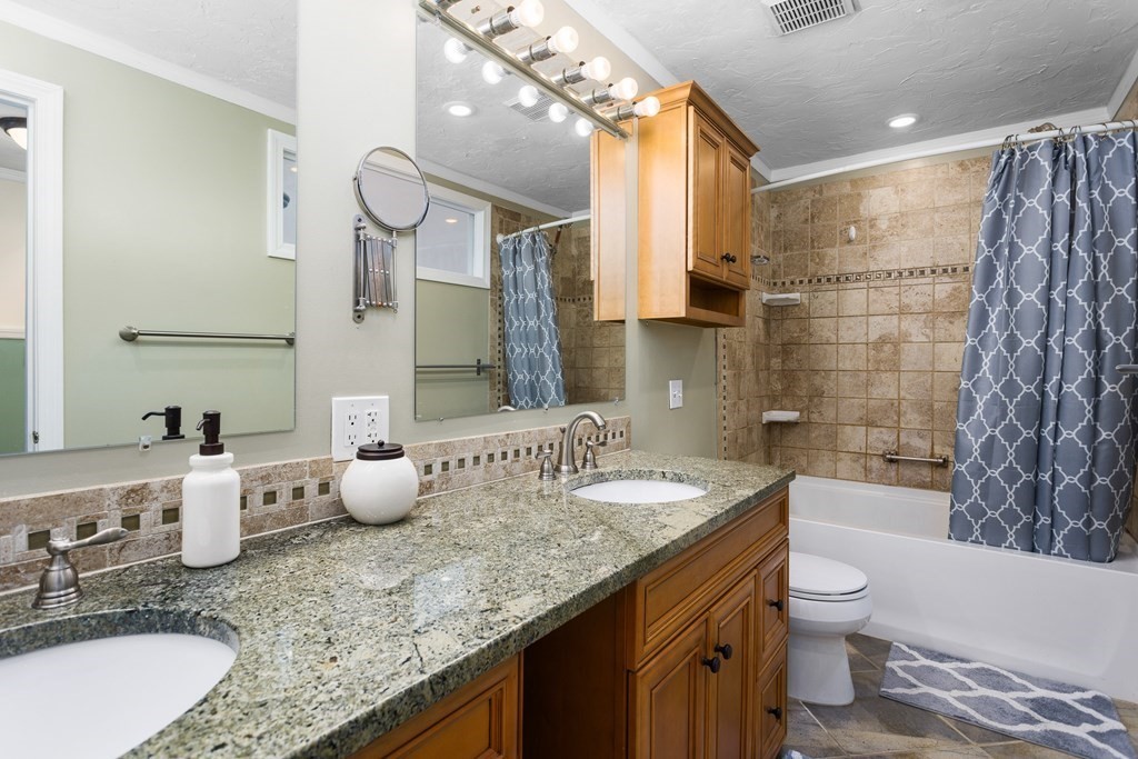 33 Trailside Way, Unit 33 Ashland, MA 01721 - Photo 15 of 26 a bathroom with a granite countertop sink and a mirror