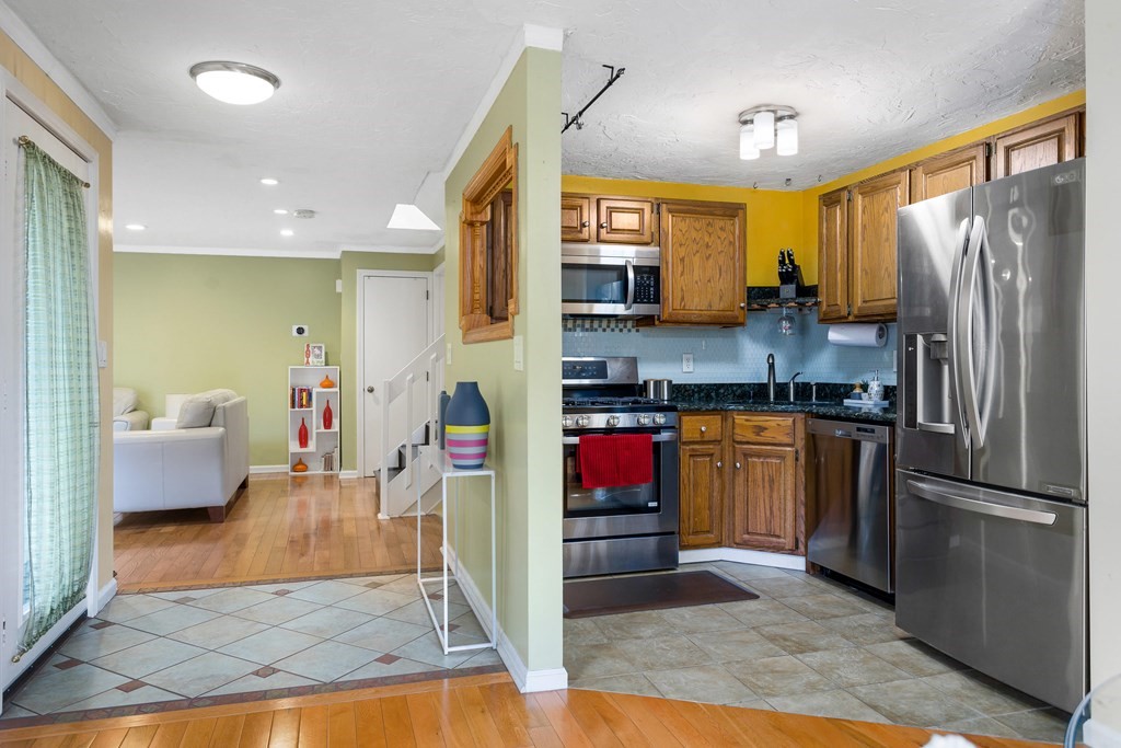 33 Trailside Way, Unit 33 Ashland, MA 01721 - Photo 2 of 26 a kitchen with stainless steel appliances granite countertop a refrigerator a stove and a sink