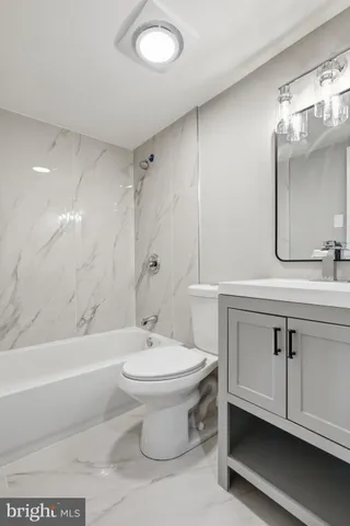 a spacious bedroom with a bed and a couch