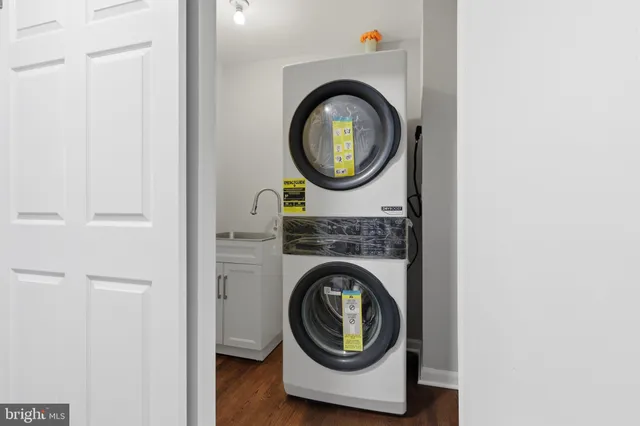 an empty room with wooden floor and closet area