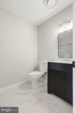 a bedroom with a bed and a refrigerator