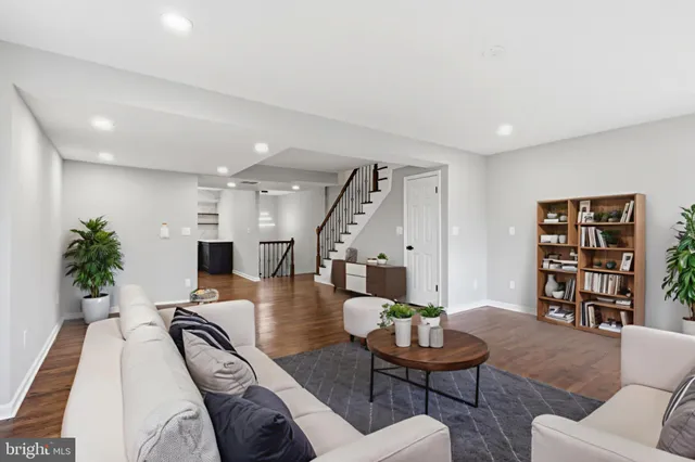 an empty room with windows and fireplace