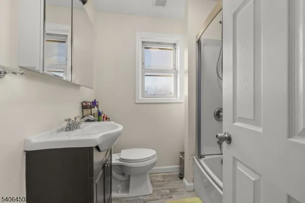 a bathroom with a sink mirror and toilet