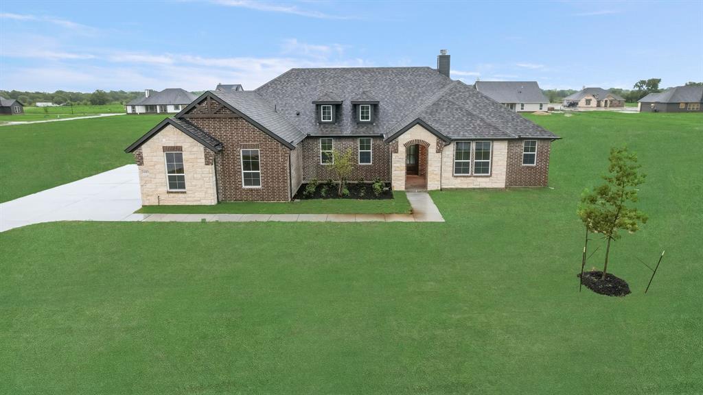a front view of house with yard and green space