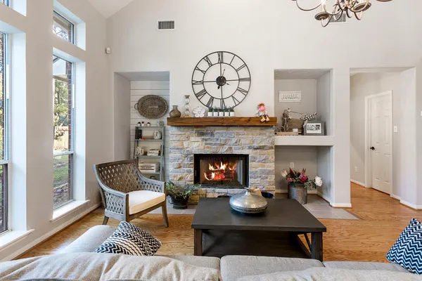 a living room with furniture a fireplace and a table