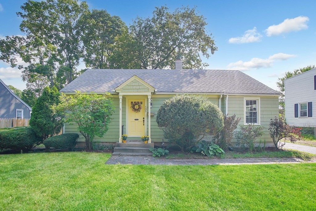 a front view of a house with garden