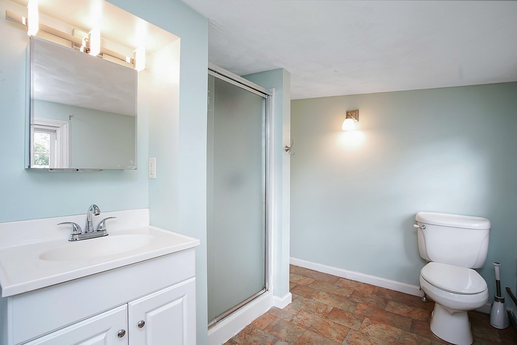 105 Lancaster Street Springfield, MA 01118 - Photo 23 of 38 a bathroom with a toilet sink and mirror