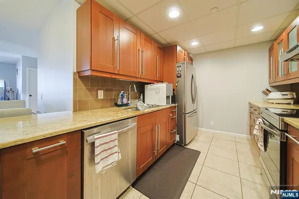 a kitchen with stainless steel appliances granite countertop a sink and cabinets