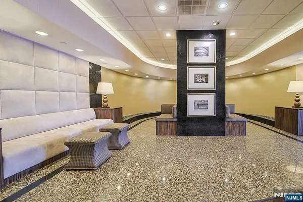 a lobby with a couch and a rug