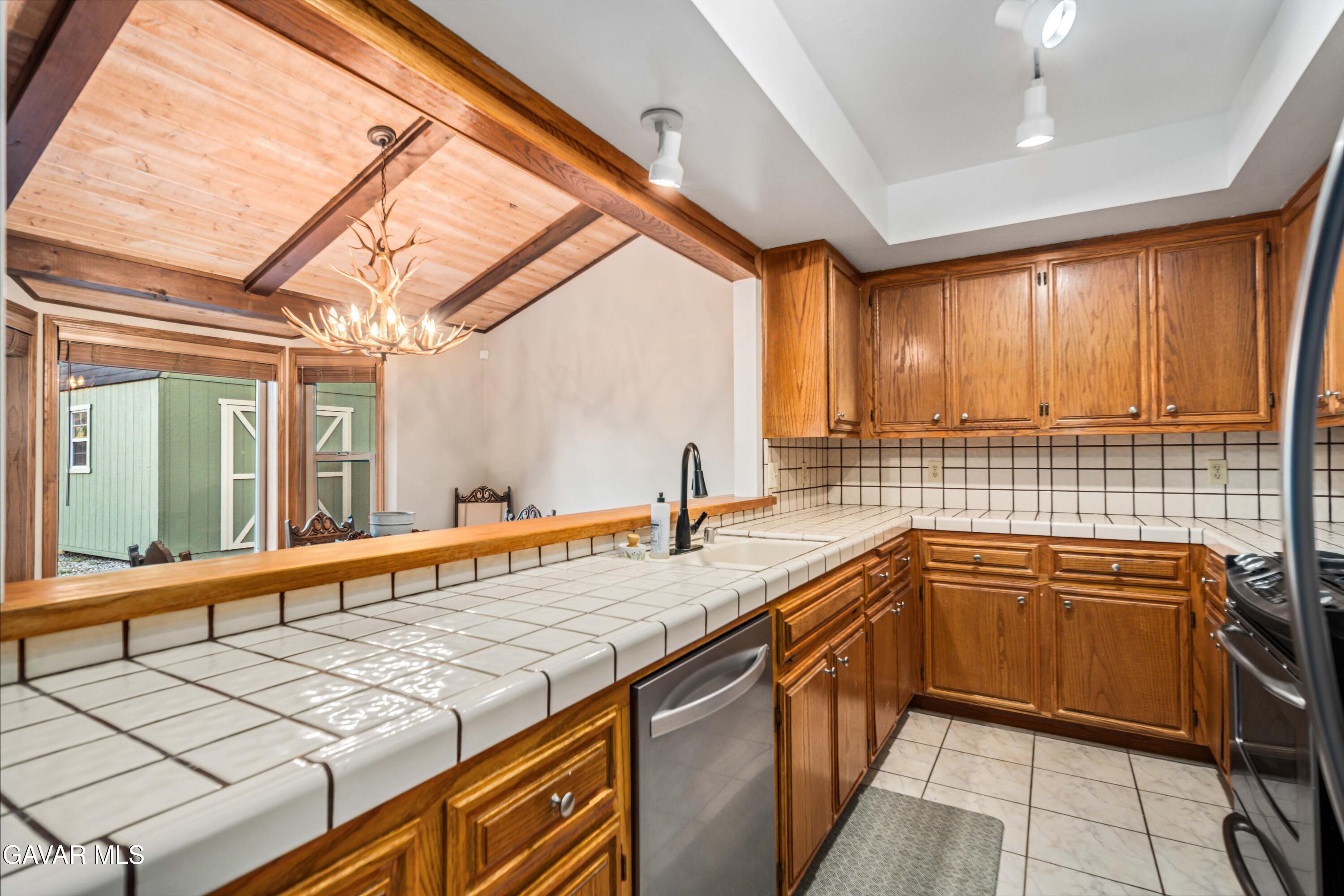 24050 Basin Harbor Court Tehachapi, CA 93561 - Photo 17 of 55 a kitchen with stainless steel appliances granite countertop a sink and cabinets