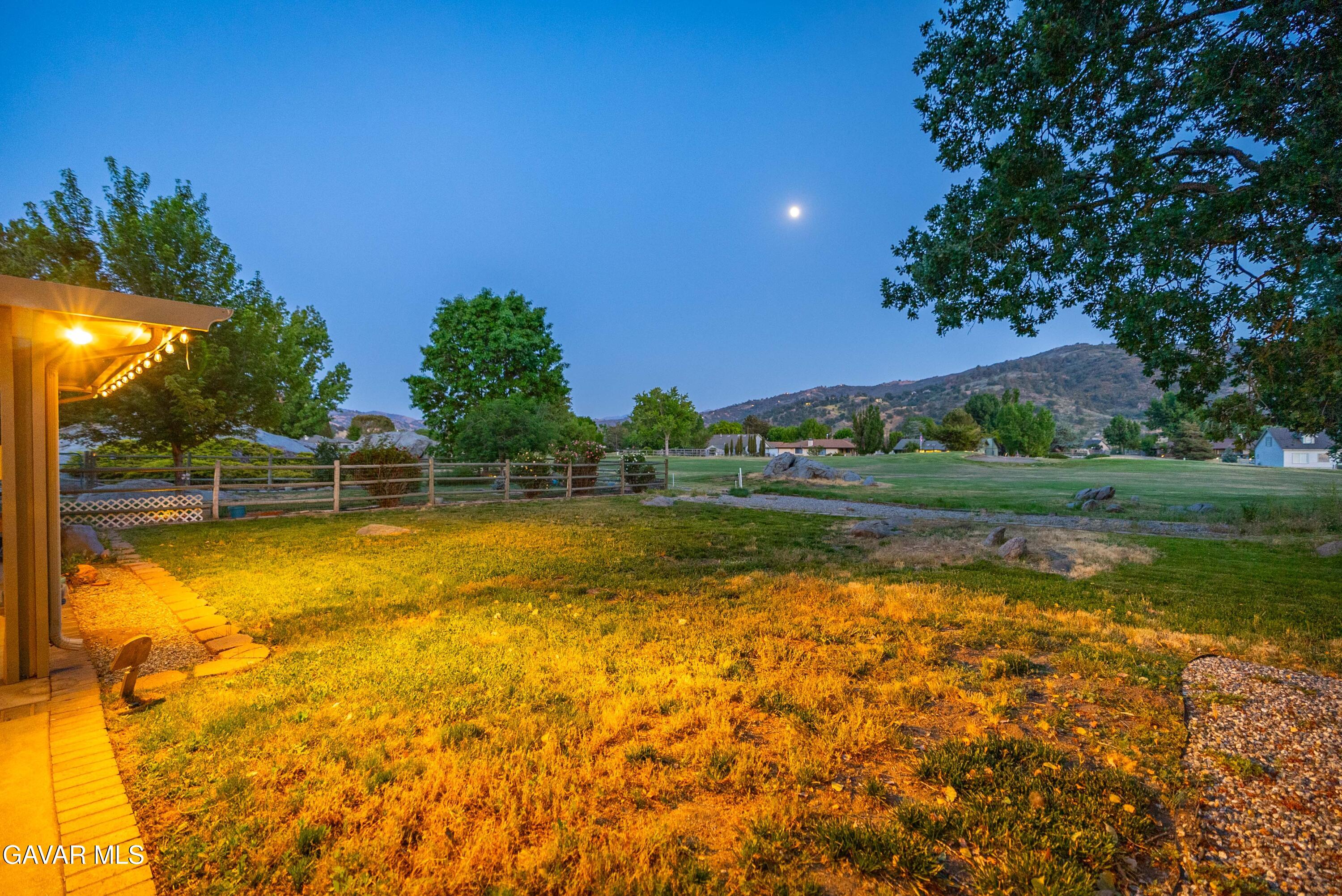 24050 Basin Harbor Court Tehachapi, CA 93561 - Photo 30 of 55 a view of a lake with a house in the background