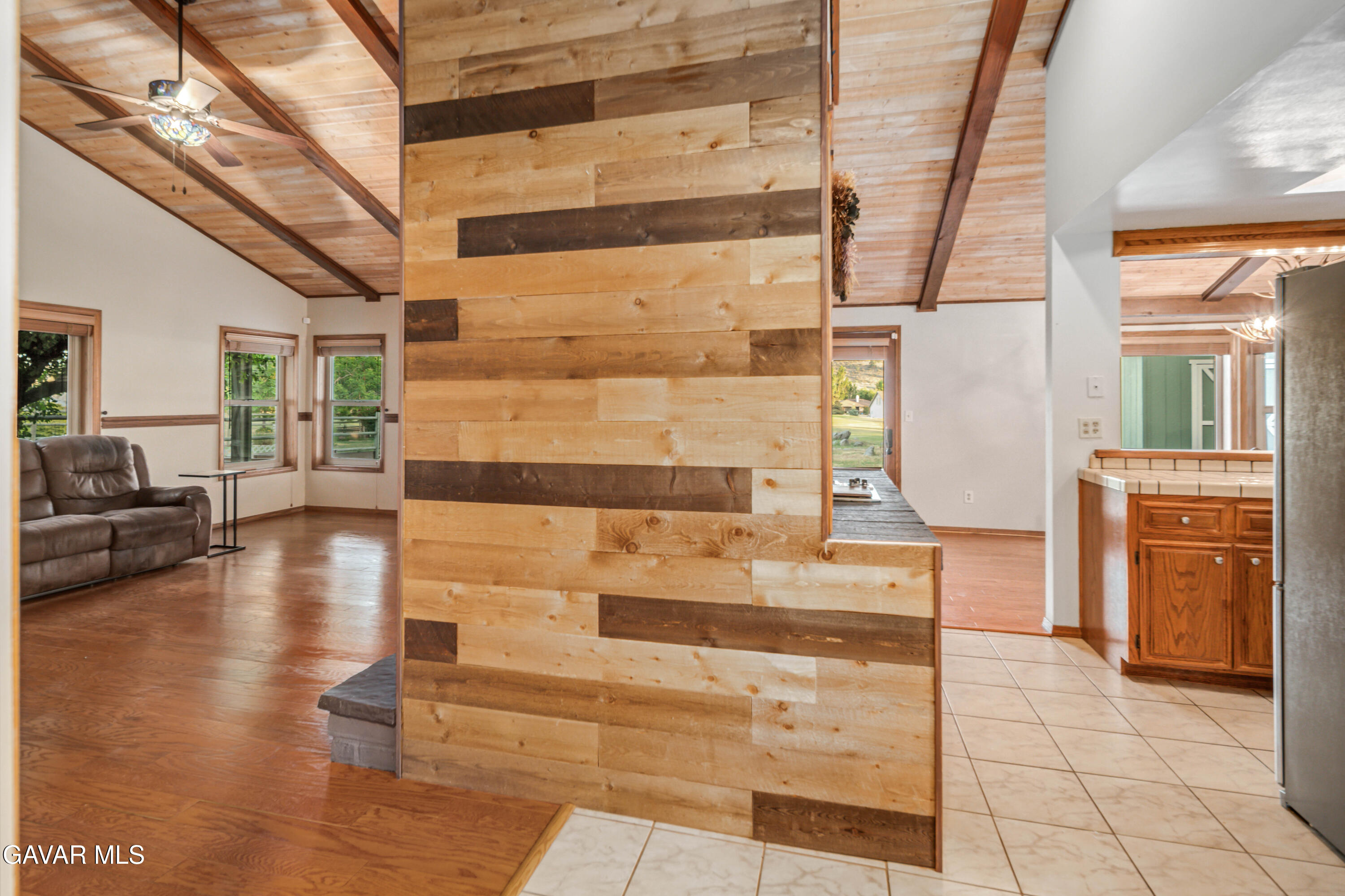 24050 Basin Harbor Court Tehachapi, CA 93561 - Photo 7 of 55 a hallway with a stove a sink and a refrigerator