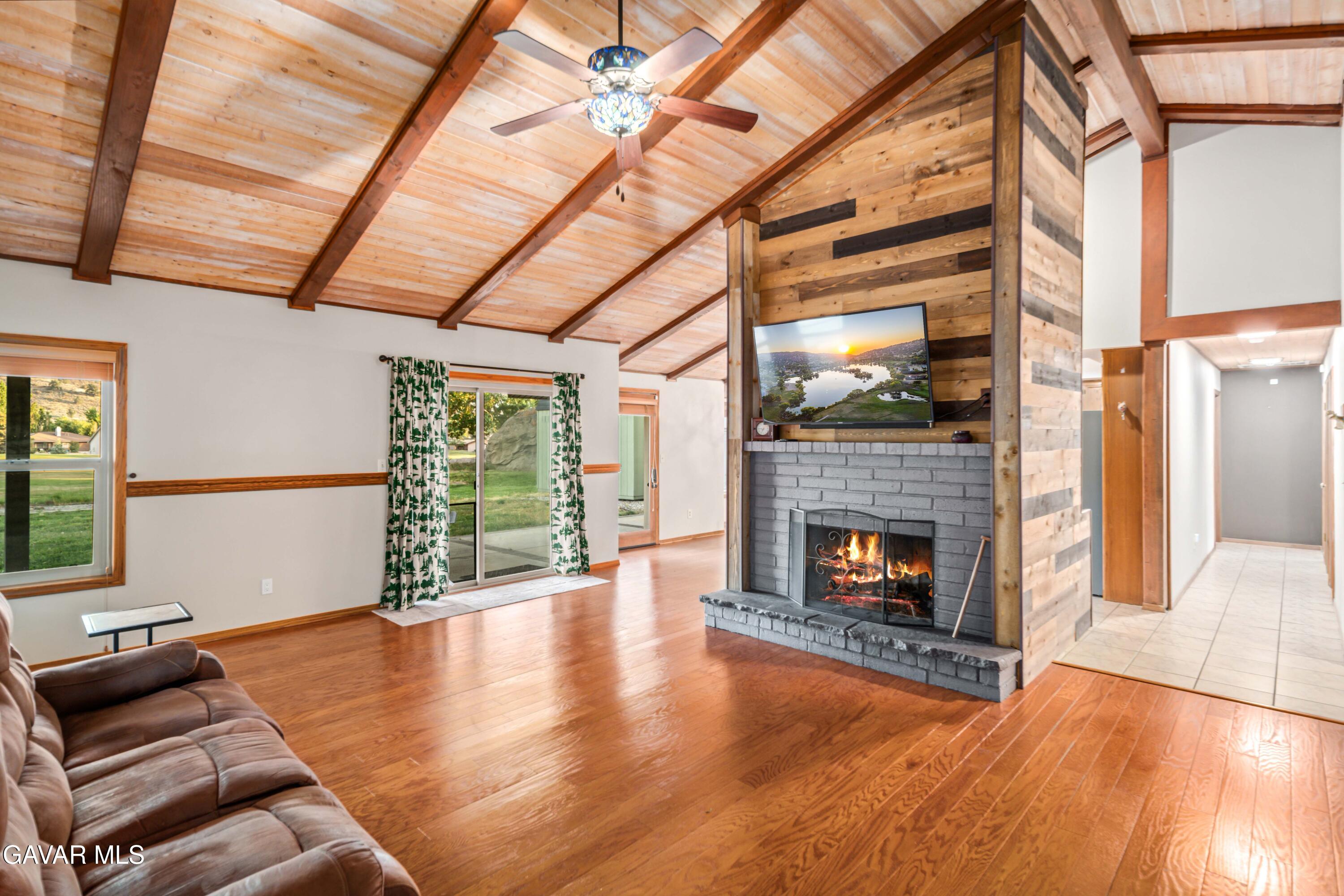 24050 Basin Harbor Court Tehachapi, CA 93561 - Photo 9 of 55 a living room with furniture fireplace and wooden floor
