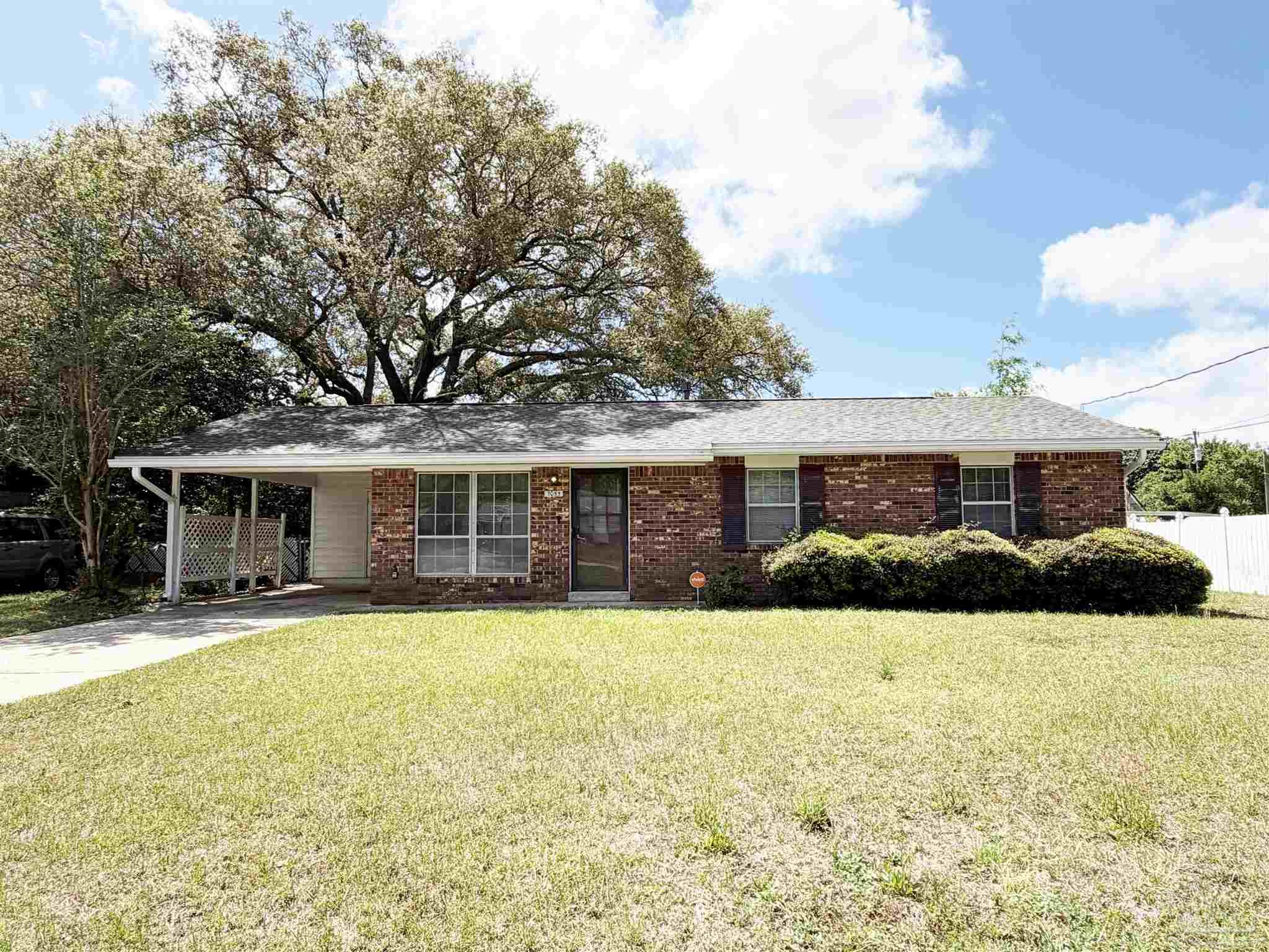 2053 Tomlinson Road Pensacola, FL 32526 - Photo 1 of 27 a front view of a house with a yard and garage