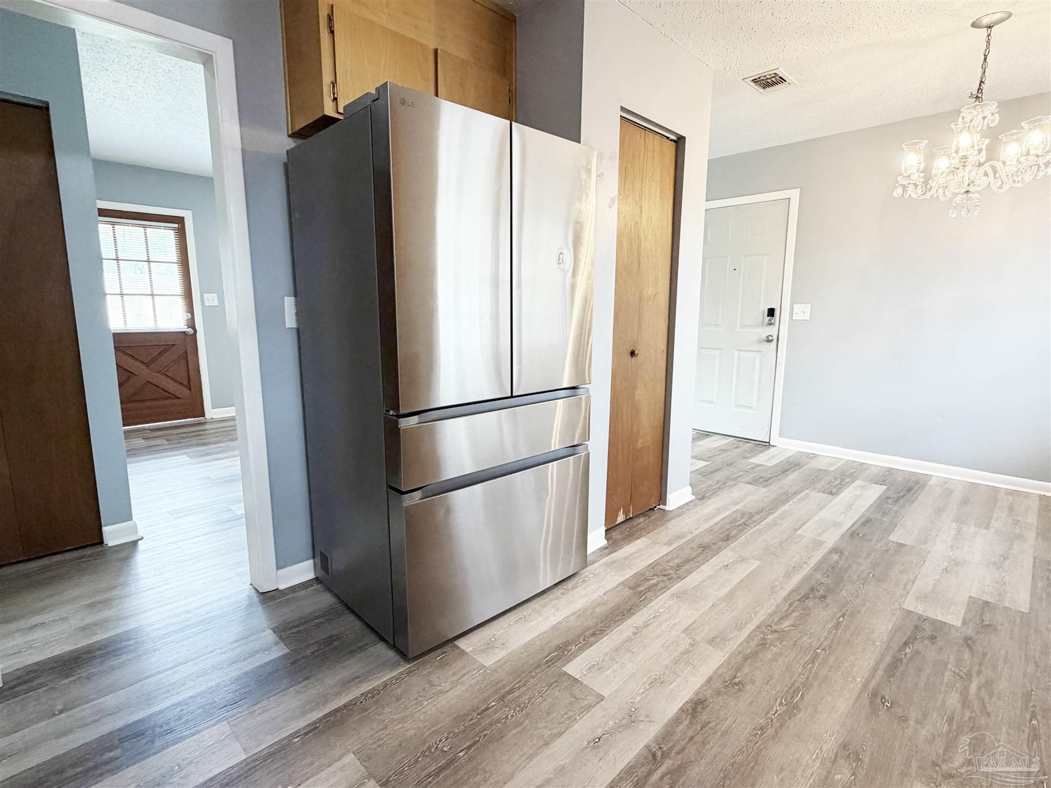 2053 Tomlinson Road Pensacola, FL 32526 - Photo 11 of 27 a kitchen with stainless steel appliances a refrigerator and a refrigerator