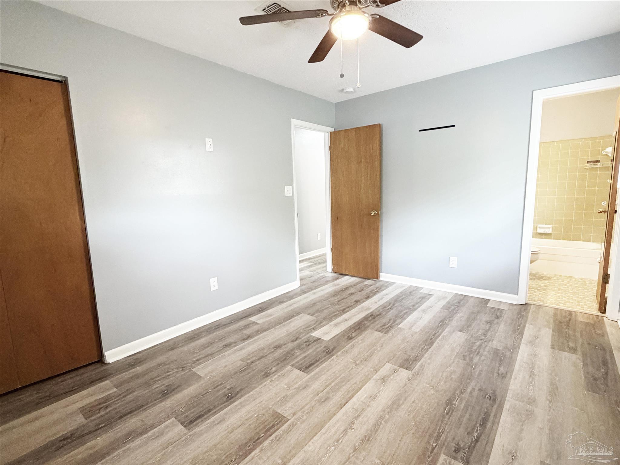 2053 Tomlinson Road Pensacola, FL 32526 - Photo 13 of 27 a view of an empty room with wooden floor
