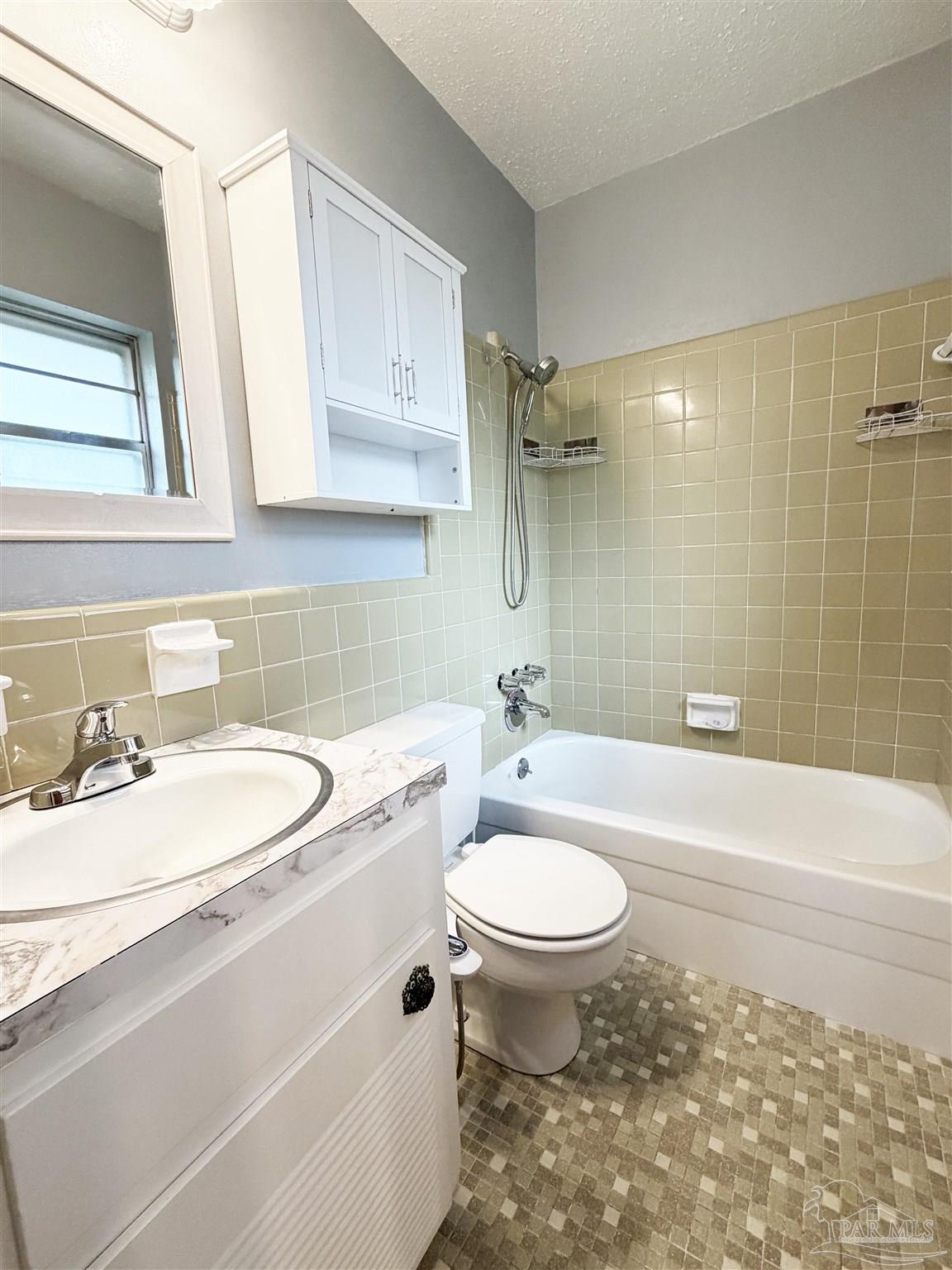 2053 Tomlinson Road Pensacola, FL 32526 - Photo 14 of 27 a bathroom with a sink toilet a mirror and shower