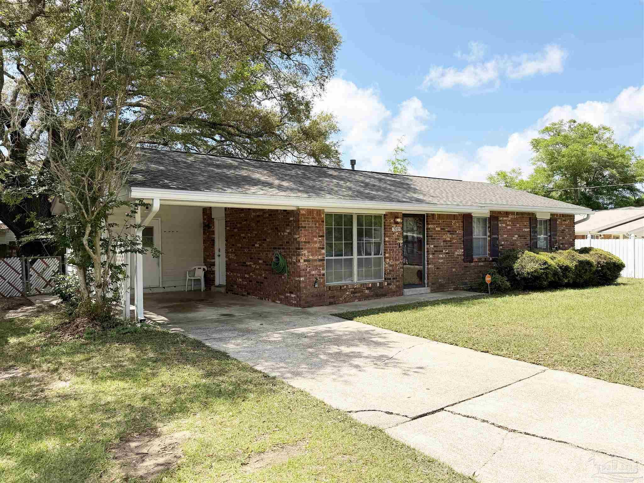 2053 Tomlinson Road Pensacola, FL 32526 - Photo 2 of 27 a front view of a house with a garden and porch