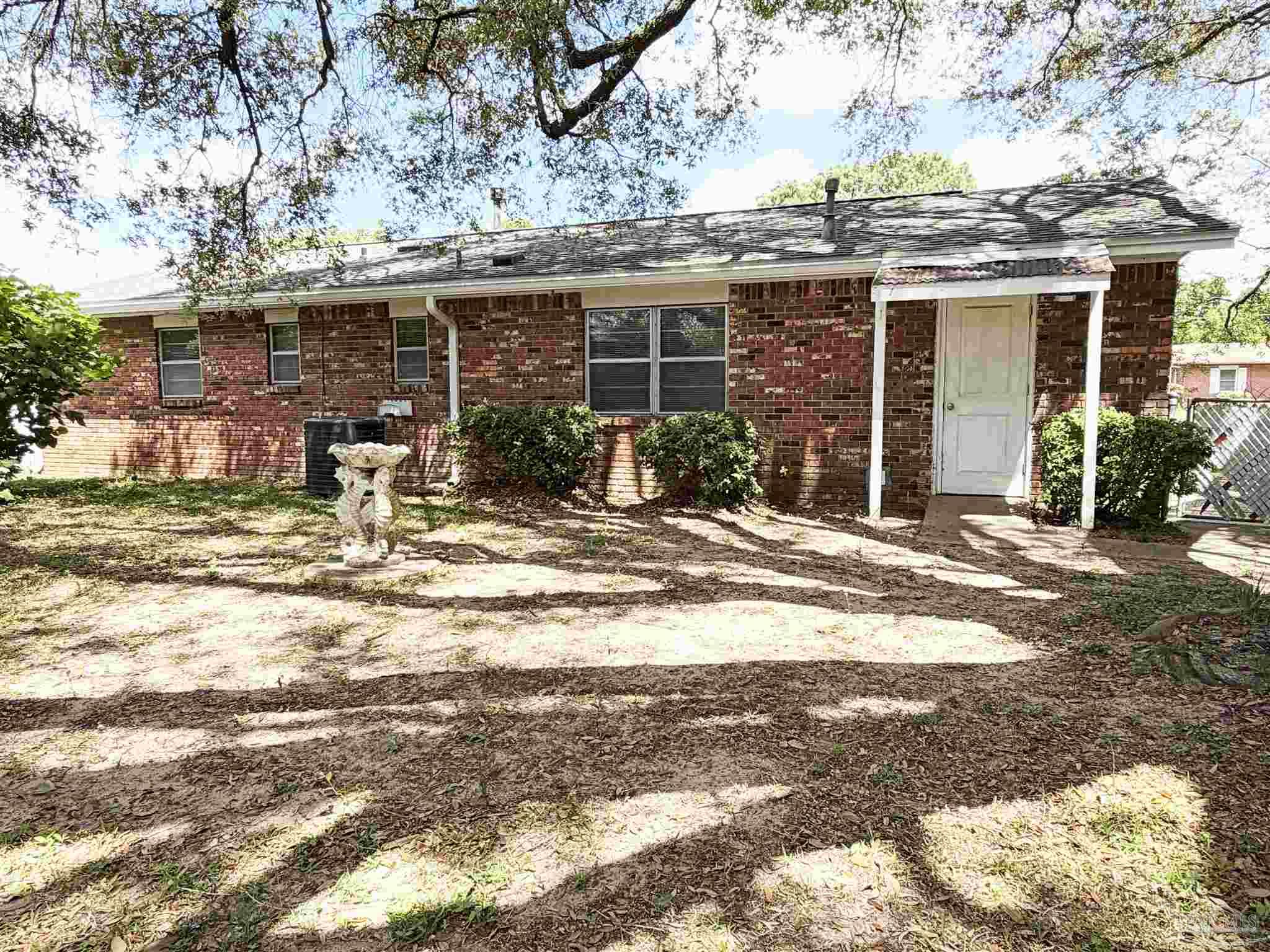 2053 Tomlinson Road Pensacola, FL 32526 - Photo 21 of 27 a front view of a house with a yard outdoor seating and garage