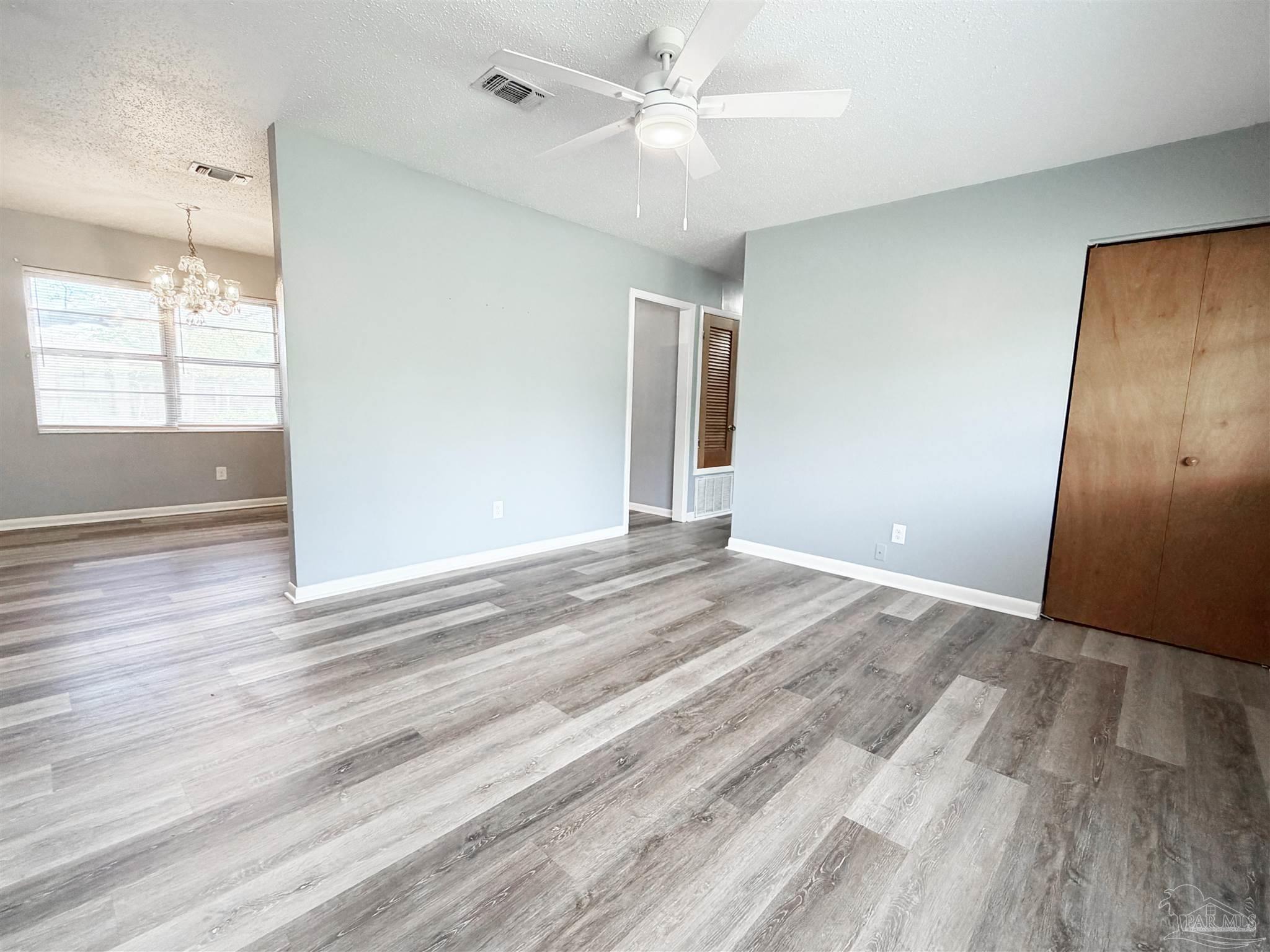 2053 Tomlinson Road Pensacola, FL 32526 - Photo 5 of 27 wooden floor in an empty room with a window