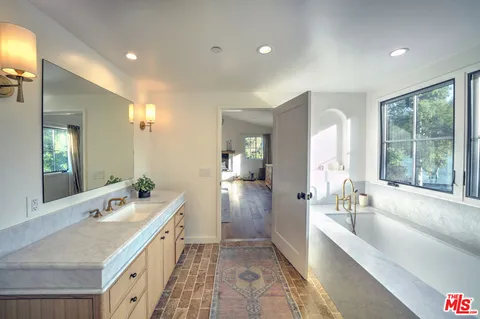 a bathroom with a bathtub and a shower