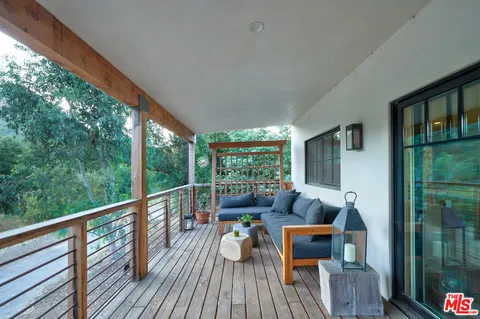 a view of a two chairs in the balcony