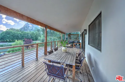 a view of balcony with furniture and wooden deck