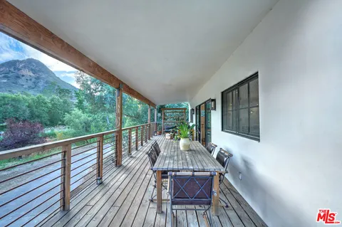 a view of balcony with wooden floor