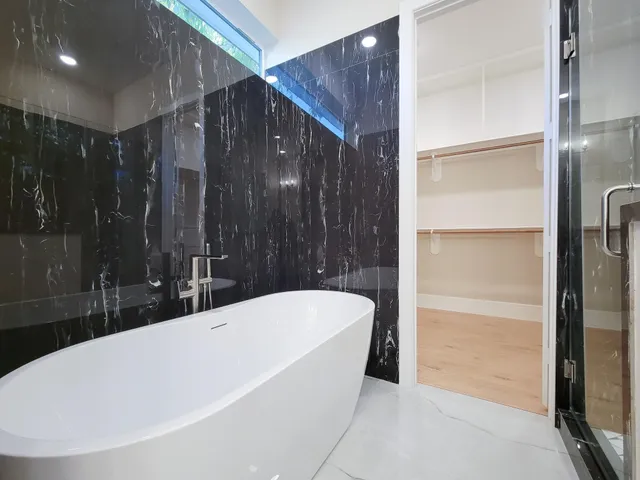 a bathroom with a bathtub and shower