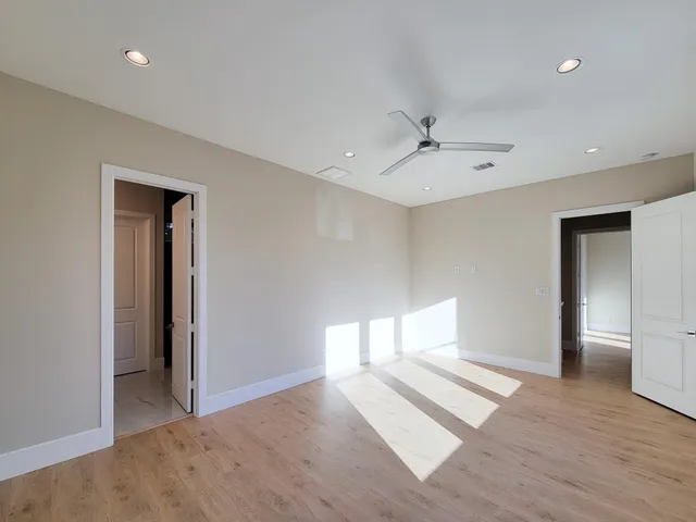 wooden floor in an empty room with a window