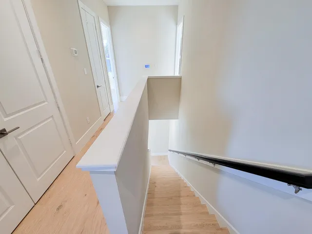 a view of staircase with white walls and a window