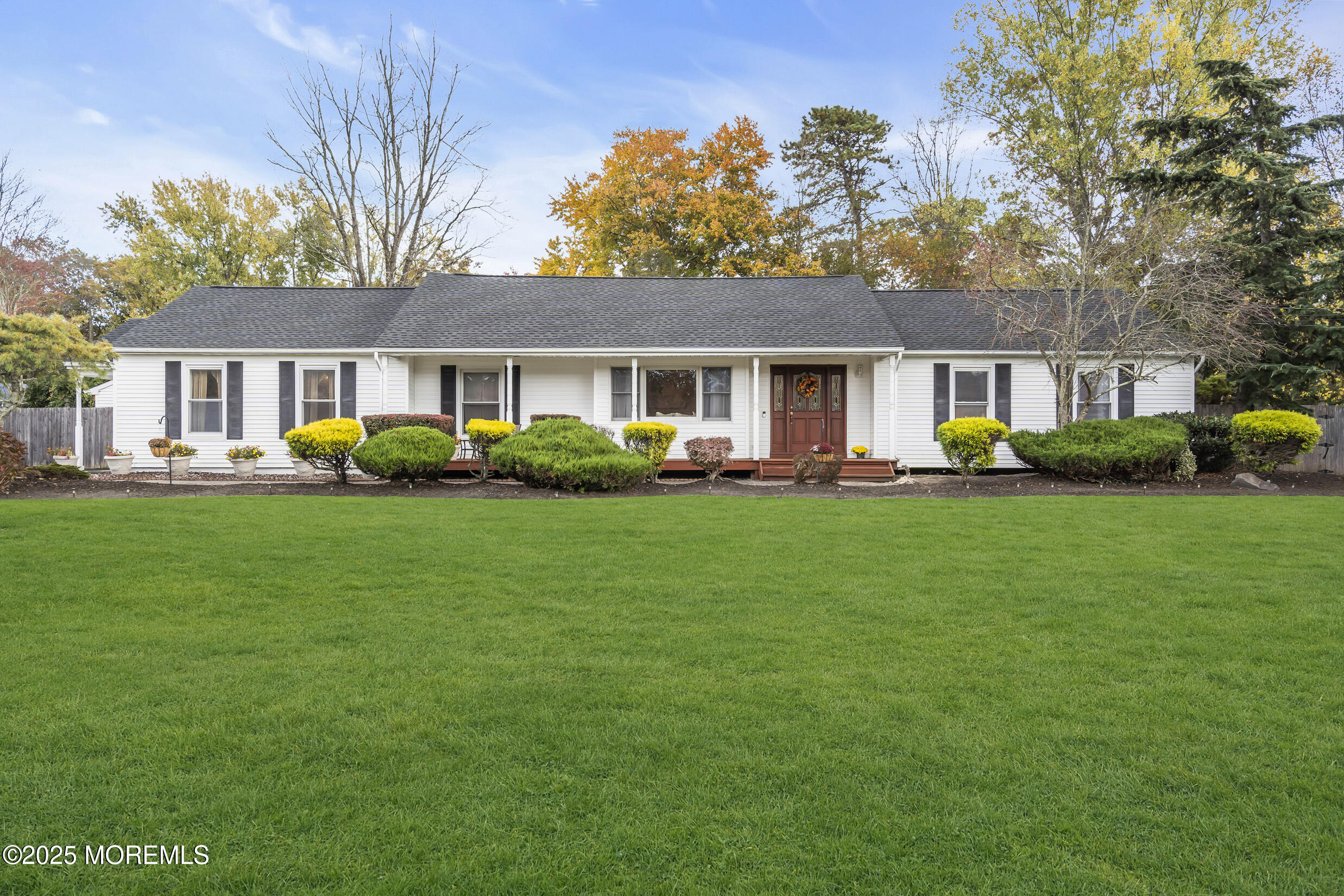a front view of house with yard and green space